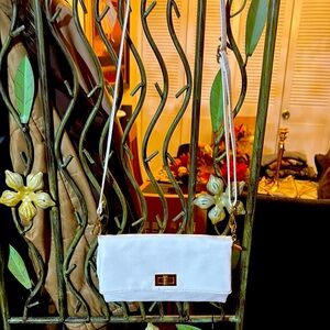 White faux leather clutch with gold metal details.